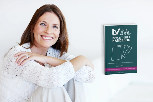 Life Values Method practitioner handbook cover beside smiling woman